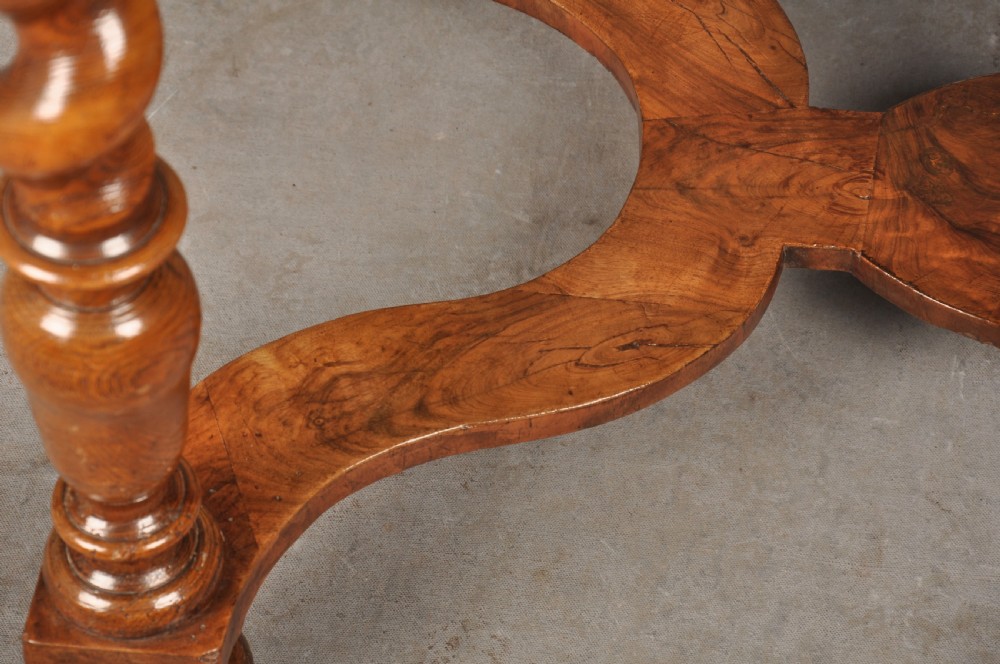 An antique olive wood side table featuring geometric oyster veneering on top, a single drawer with a brass drop handle, four barley twist legs, and a curved stretcher base. View XI