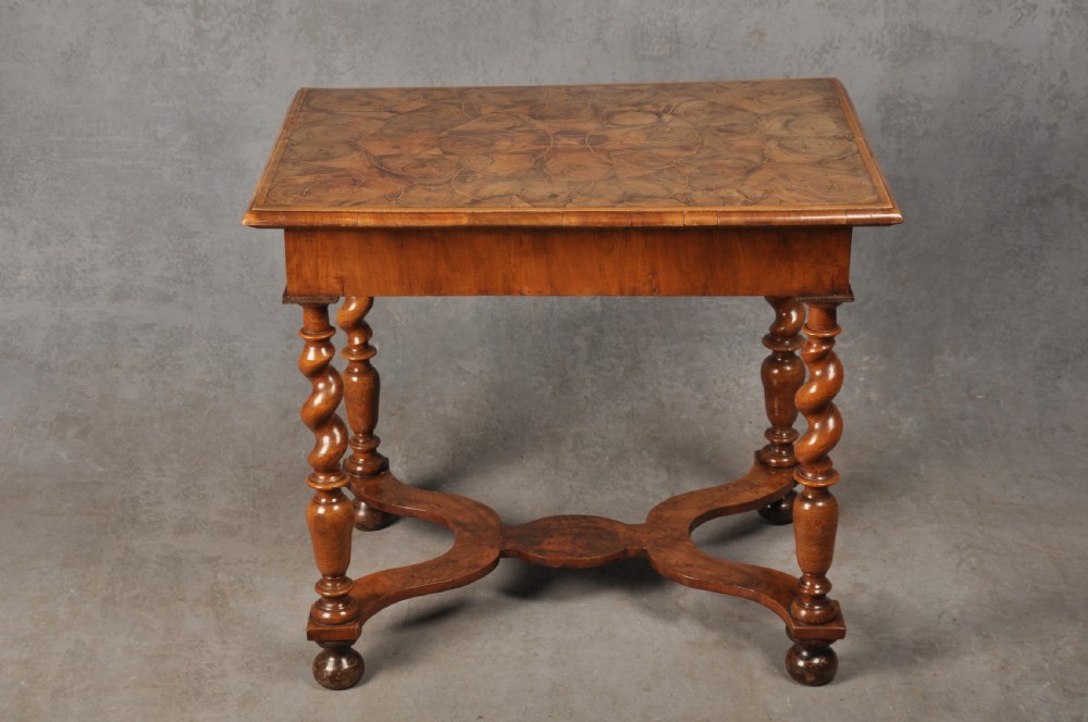 An antique olive wood side table featuring geometric oyster veneering on top, a single drawer with a brass drop handle, four barley twist legs, and a curved stretcher base. View XII