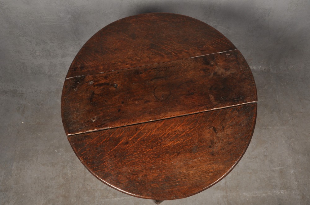A small dark brown Queen Anne oak gateleg table shown with both drop leaves lowered, featuring turned legs and a stretcher base. View III