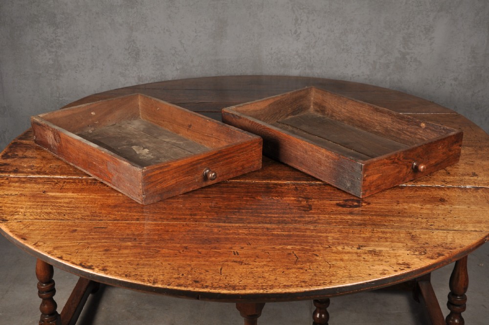 A large 17th-century solid oak gateleg dining table with two drop leaves, turned legs, and square box stretchers. View VI