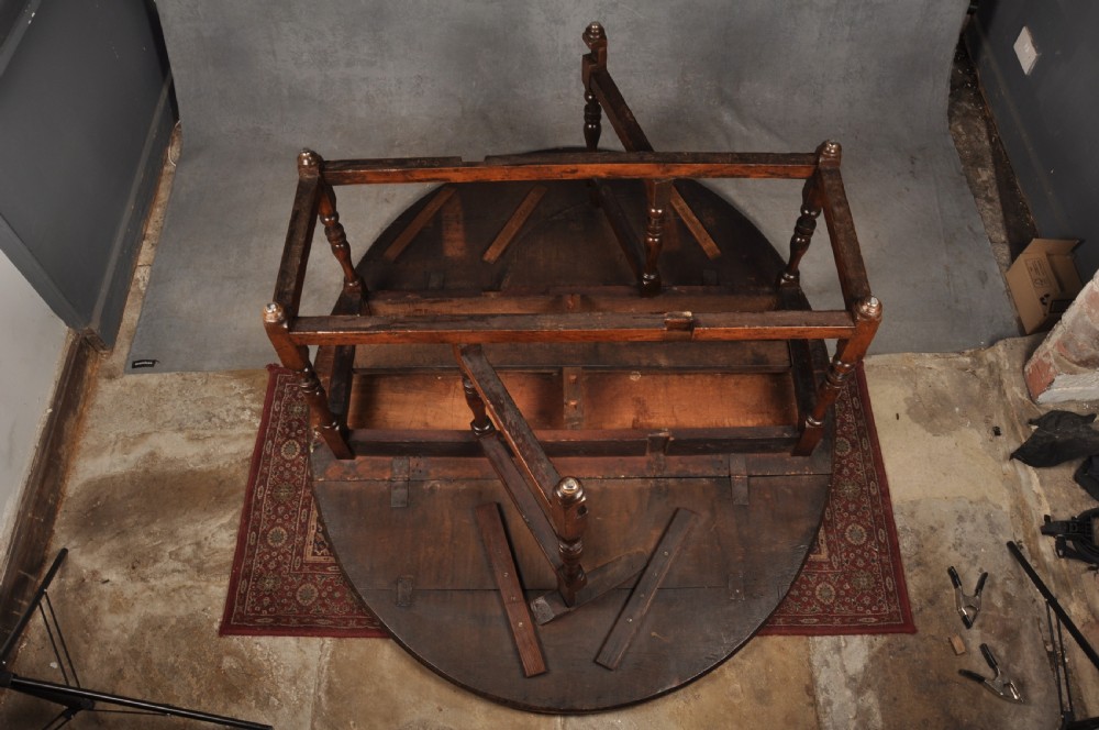 A large 17th-century solid oak gateleg dining table with two drop leaves, turned legs, and square box stretchers. View VIII