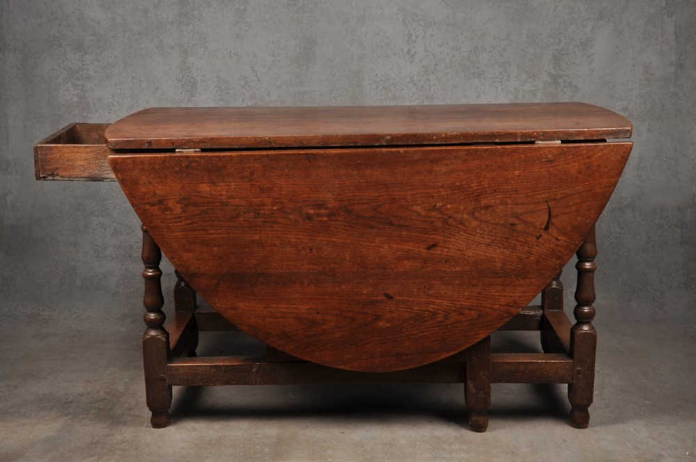 A seventeenth-century oak gateleg dining table featuring hinged drop leaves and turned wood legs with low stretchers. View IV
