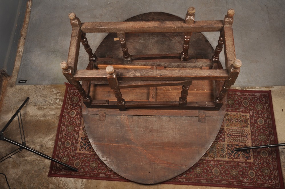 A seventeenth-century oak gateleg dining table featuring hinged drop leaves and turned wood legs with low stretchers. View VI