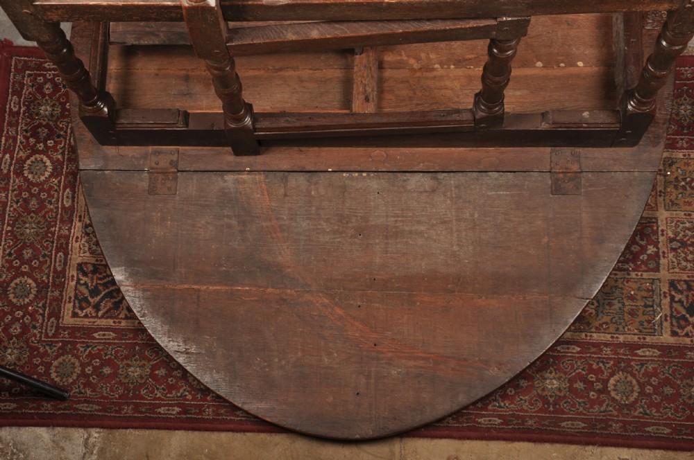 A seventeenth-century oak gateleg dining table featuring hinged drop leaves and turned wood legs with low stretchers. View VIII