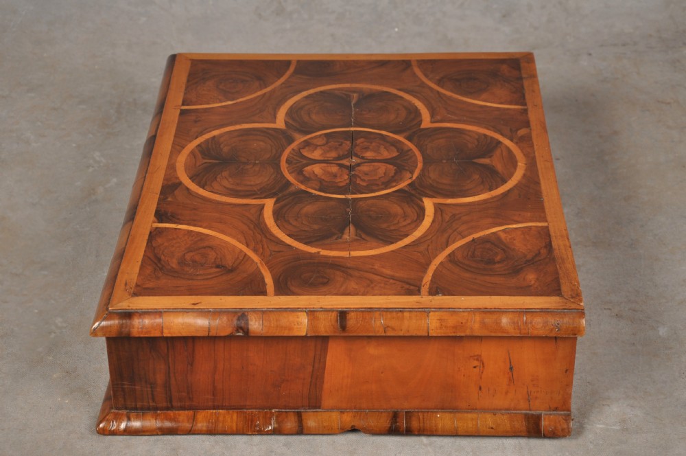 A rectangular 17th-century olive wood lace box featuring geometric oyster veneer marquetry on the lid and a brass keyhole escutcheon on the front. View III