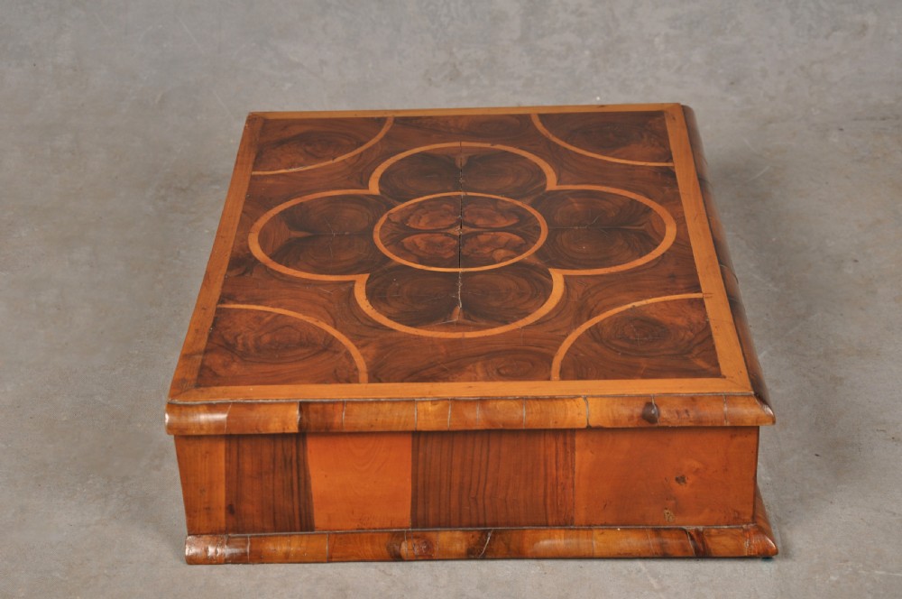 A rectangular 17th-century olive wood lace box featuring geometric oyster veneer marquetry on the lid and a brass keyhole escutcheon on the front. View IV
