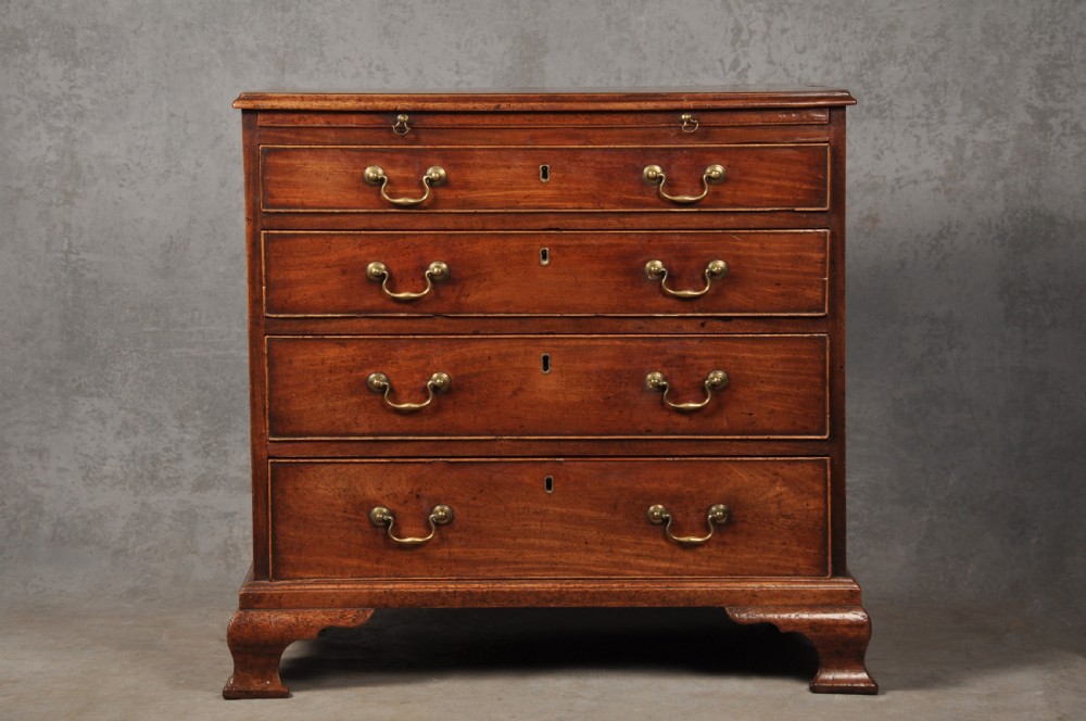 An 18th-century Georgian mahogany chest of drawers featuring four graduated drawers, brass swan-neck handles, a brushing slide, and bracket feet. View II