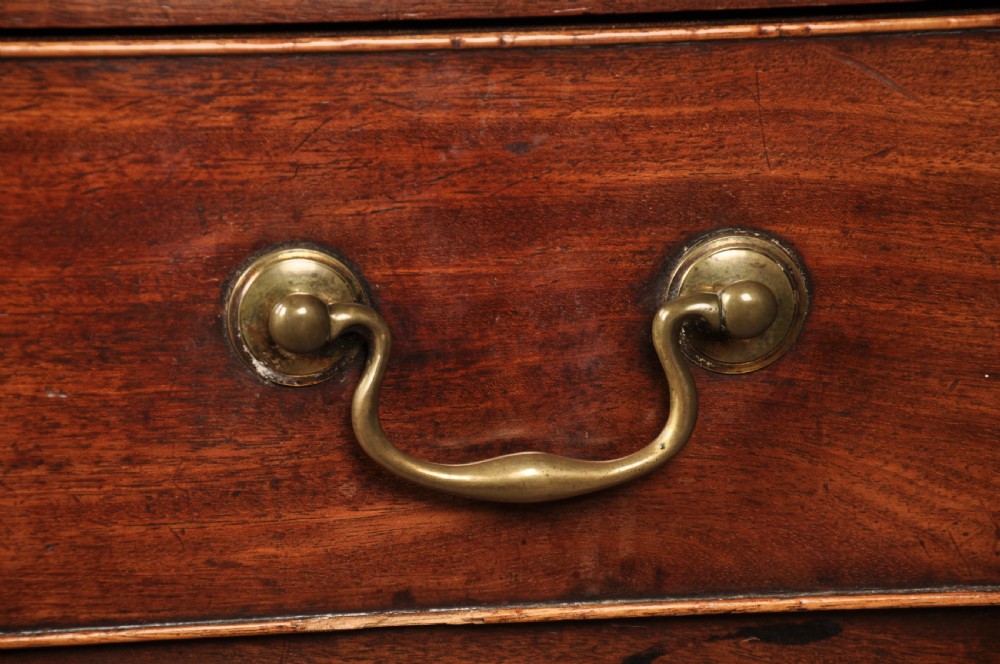 An 18th-century Georgian mahogany chest of drawers featuring four graduated drawers, brass swan-neck handles, a brushing slide, and bracket feet. View III