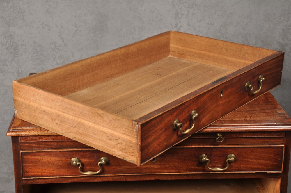 An 18th-century Georgian mahogany chest of drawers featuring four graduated drawers, brass swan-neck handles, a brushing slide, and bracket feet. View VIII