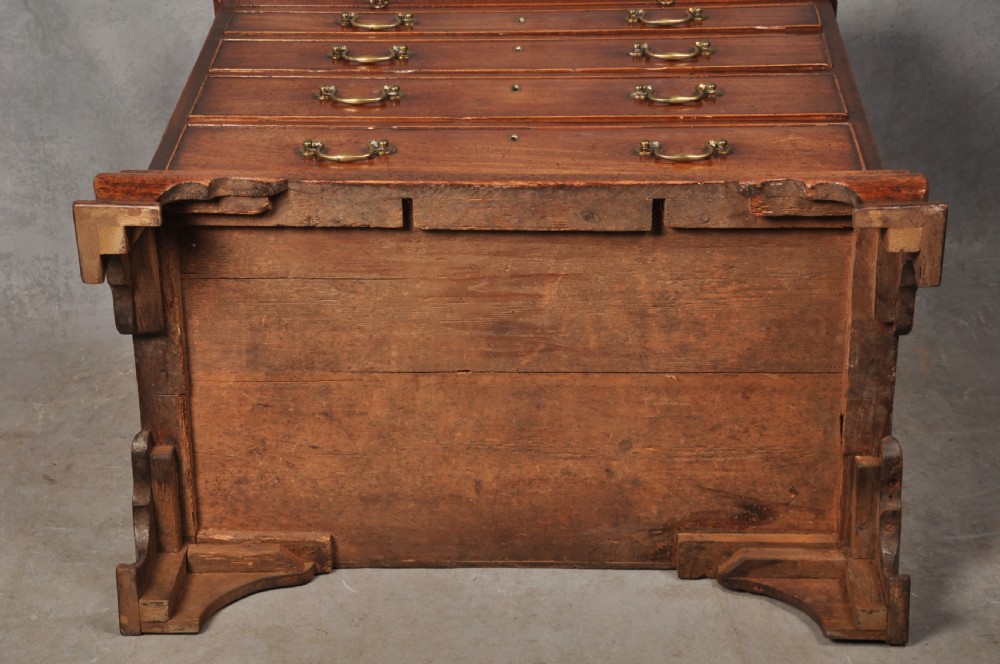 An 18th-century Georgian mahogany chest of drawers featuring four graduated drawers, brass swan-neck handles, a brushing slide, and bracket feet. View X