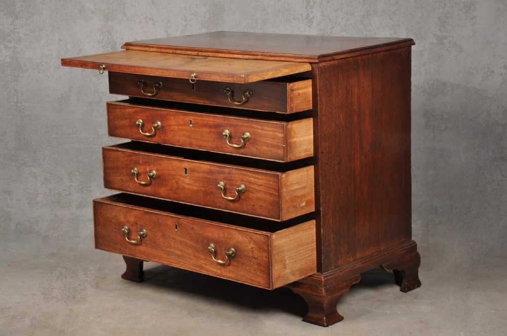 An 18th-century Georgian mahogany chest of drawers featuring four graduated drawers, brass swan-neck handles, a brushing slide, and bracket feet. View XII