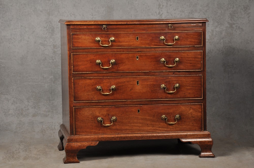 An 18th-century Georgian mahogany chest of drawers featuring four graduated drawers, brass swan-neck handles, a brushing slide, and bracket feet. View XIII