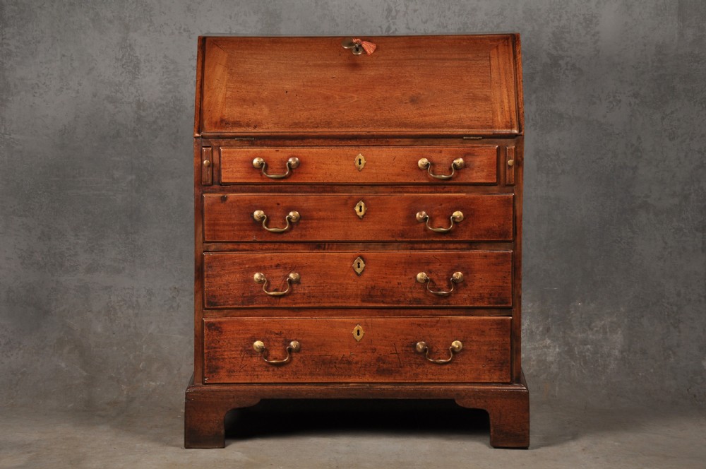 An 18th-century mahogany slant-front writing bureau featuring four graduated drawers with brass handles, standing on bracket feet. View II