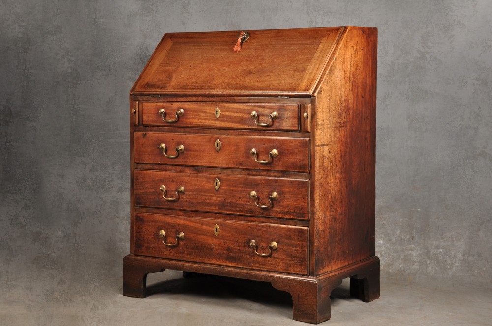 An 18th-century mahogany slant-front writing bureau featuring four graduated drawers with brass handles, standing on bracket feet. View III