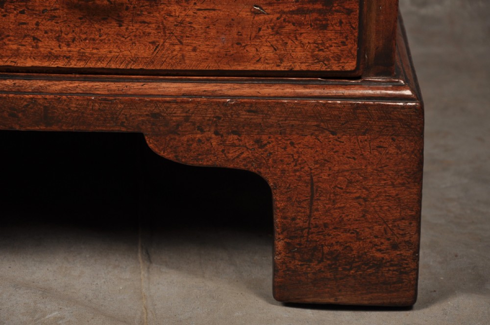 An 18th-century mahogany slant-front writing bureau featuring four graduated drawers with brass handles, standing on bracket feet. View IX