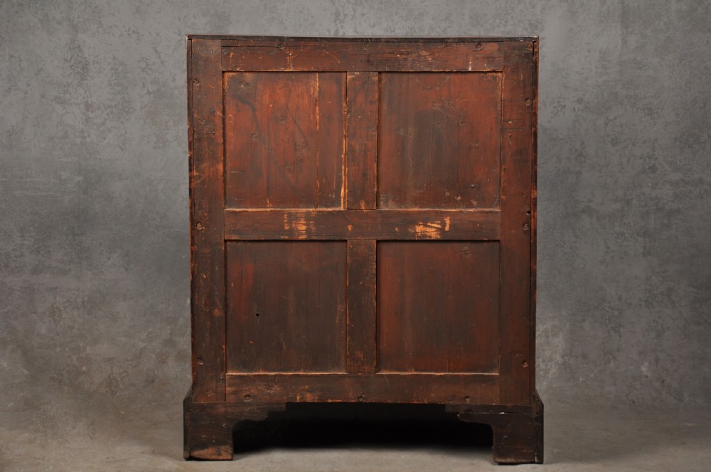 An 18th-century mahogany slant-front writing bureau featuring four graduated drawers with brass handles, standing on bracket feet. View X
