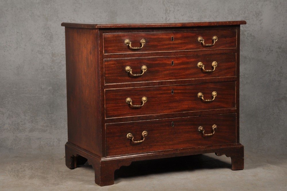 A Georgian mahogany chest featuring four graduated drawers with brass swan-neck handles and bracket feet. View II