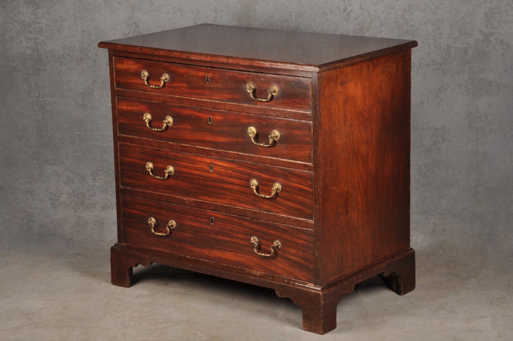 A Georgian mahogany chest featuring four graduated drawers with brass swan-neck handles and bracket feet. View III
