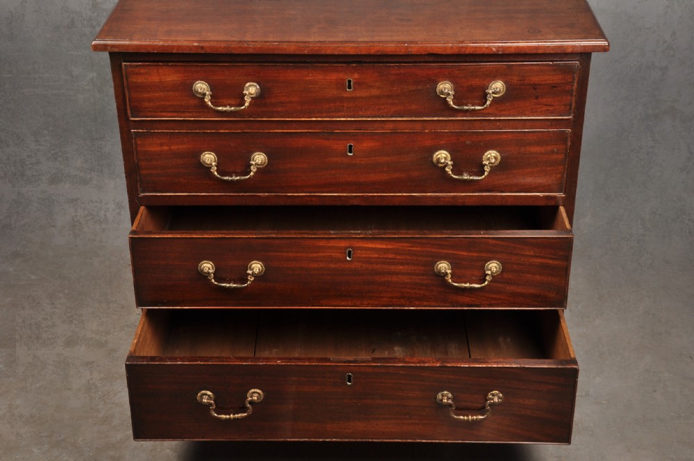 A Georgian mahogany chest featuring four graduated drawers with brass swan-neck handles and bracket feet. View VI