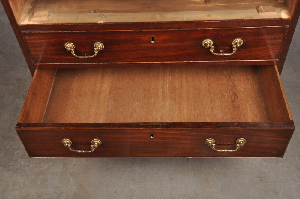 A Georgian mahogany chest featuring four graduated drawers with brass swan-neck handles and bracket feet. View VII