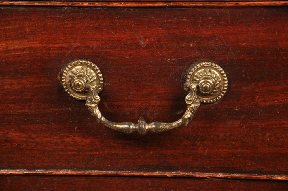 A Georgian mahogany chest featuring four graduated drawers with brass swan-neck handles and bracket feet. View IX