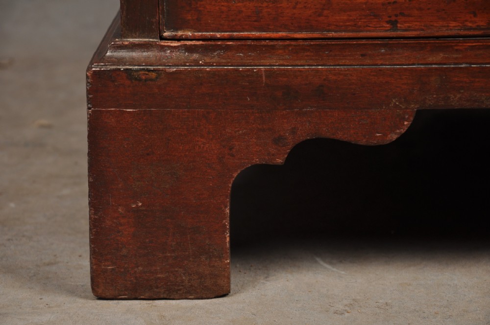 A Georgian mahogany chest featuring four graduated drawers with brass swan-neck handles and bracket feet. View X