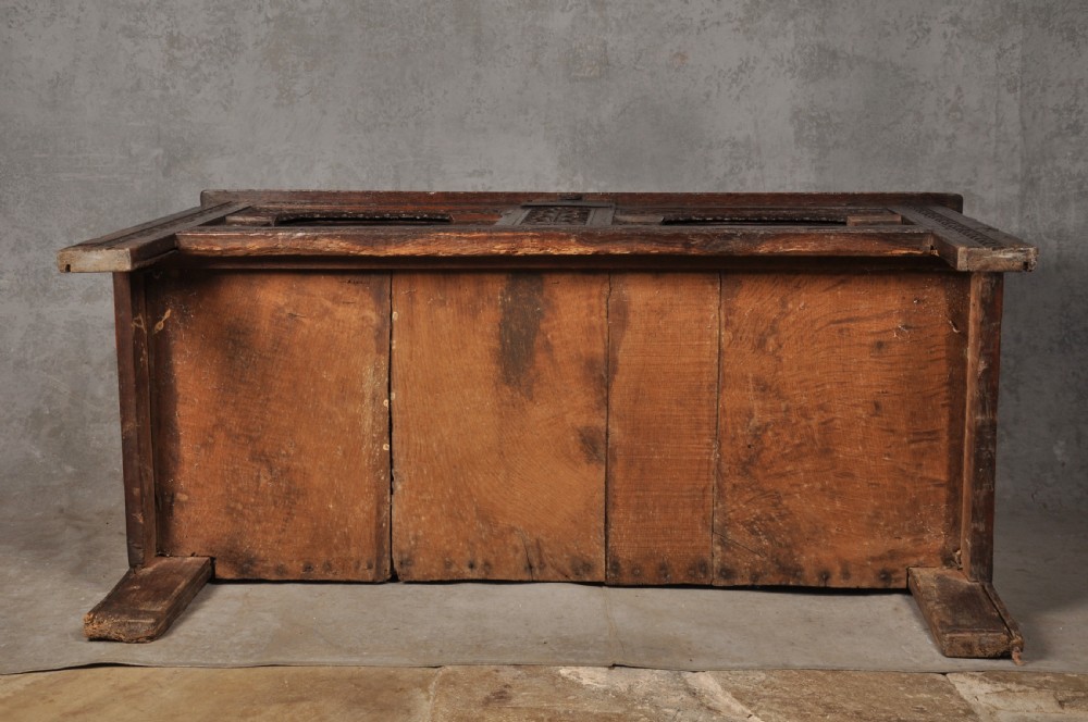 Early 17th-century dark carved oak coffer featuring dual arched panels with geometric inlay and an iron lock plate. View XI