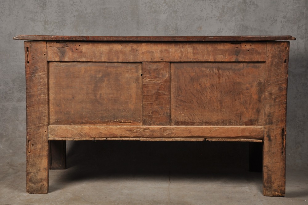 Early 17th-century dark carved oak coffer featuring dual arched panels with geometric inlay and an iron lock plate. View XII