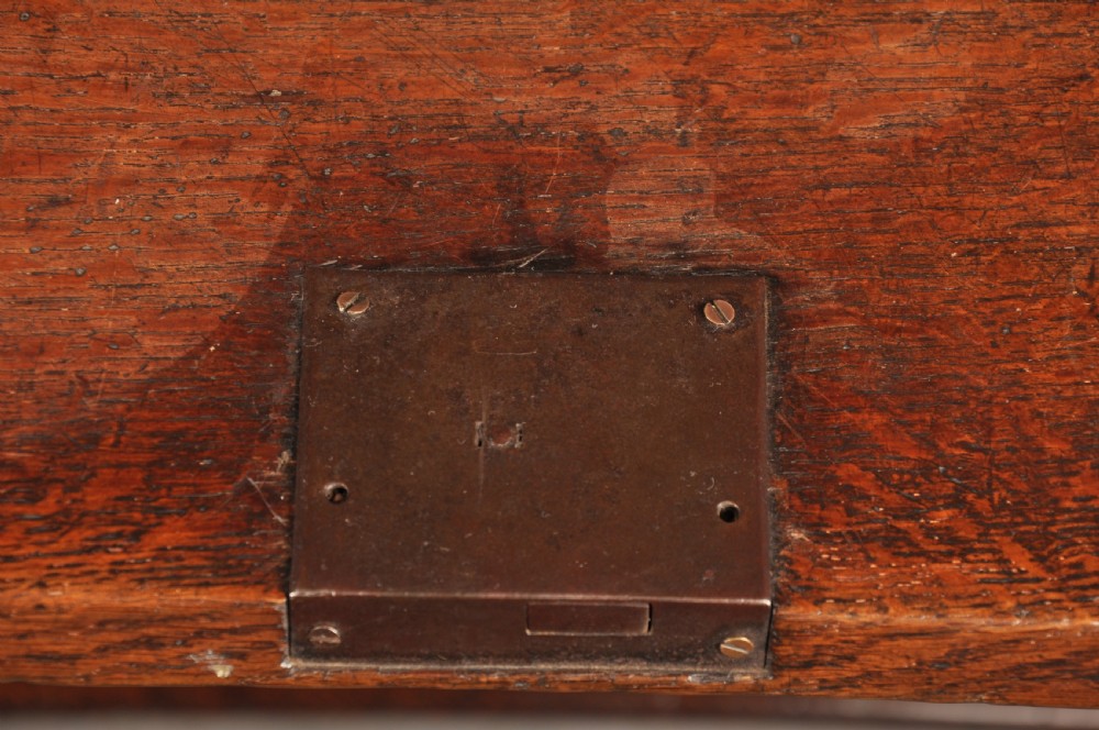 A 17th-century dark oak bureau featuring a sloped drop-down lid, geometric moulded drawers, and iron keyhole escutcheons. View VIII