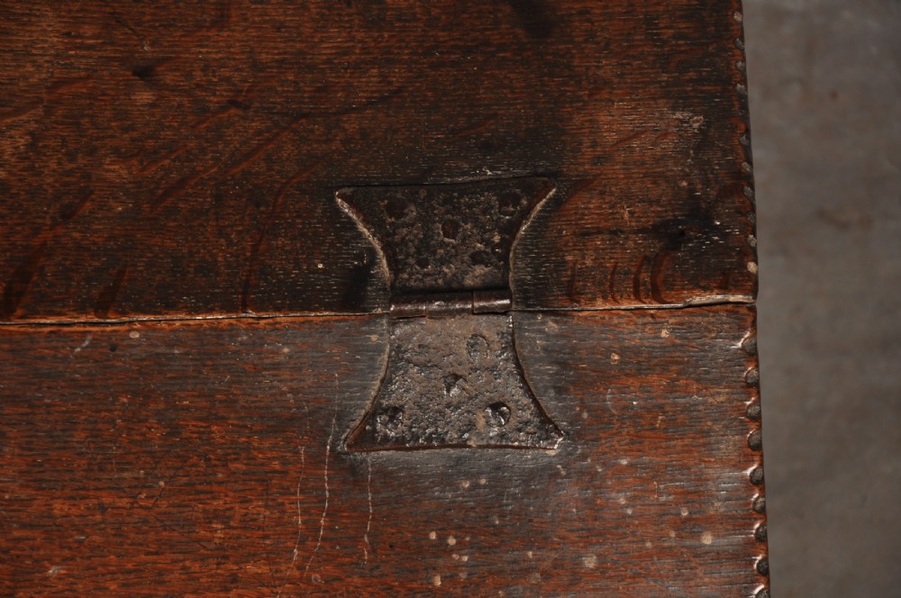 A seventeenth-century dark oak slant-front desk box with relief rosette carvings and iron hardware. View II