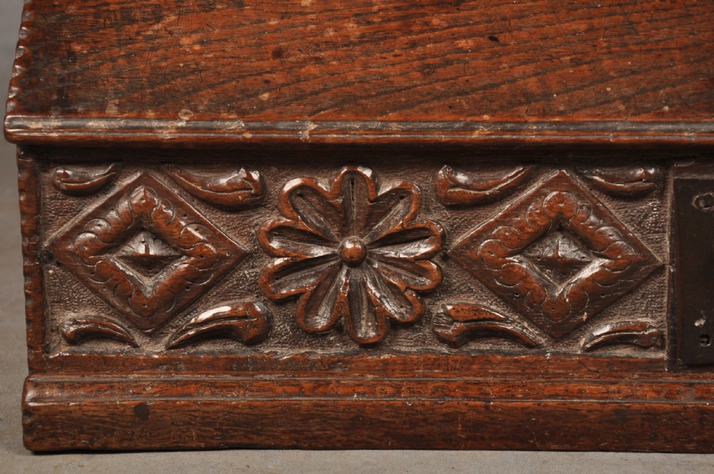 A seventeenth-century dark oak slant-front desk box with relief rosette carvings and iron hardware. View III