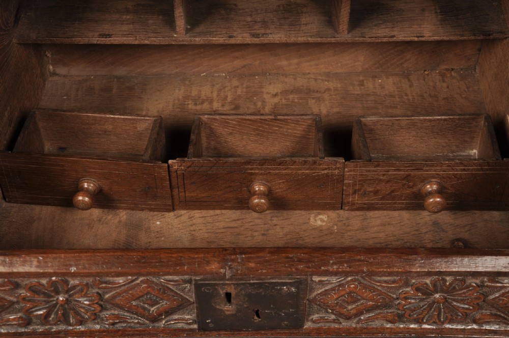 A seventeenth-century dark oak slant-front desk box with relief rosette carvings and iron hardware. View VIII