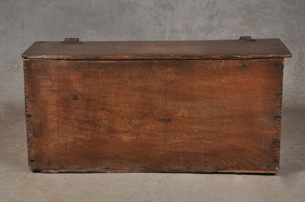 A seventeenth-century dark oak slant-front desk box with relief rosette carvings and iron hardware. View IX