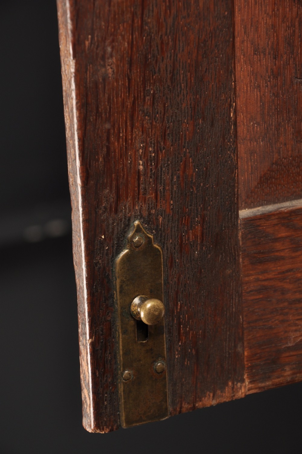 An early 18th-century dark oak bureau bookcase with a two-door upper section, a sloped writing fall, and long drawers on bracket feet. View XI