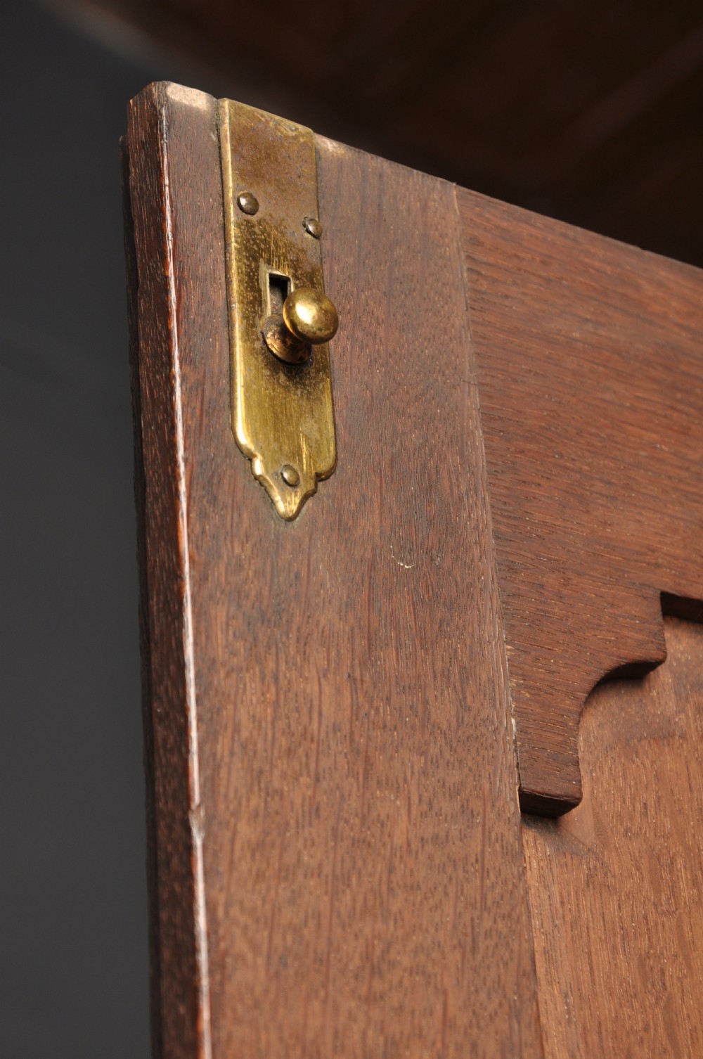 An early 18th-century dark oak bureau bookcase with a two-door upper section, a sloped writing fall, and long drawers on bracket feet. View XII