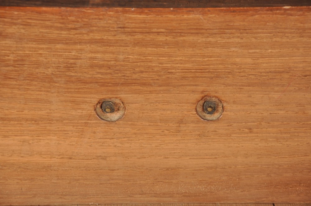 An 18th-century Georgian oak chest of drawers featuring two short drawers over three long drawers with brass drop handles and bracket feet. View X
