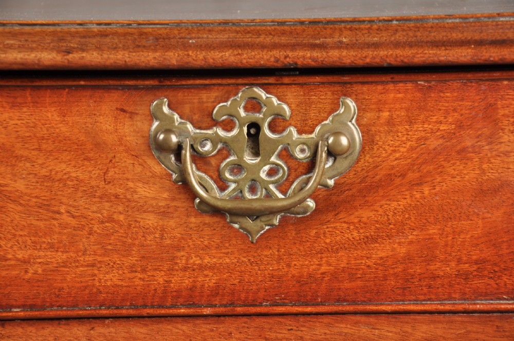 An 18th-century Georgian mahogany chest of drawers featuring two short over three long drawers with brass hardware and bracket feet. View II
