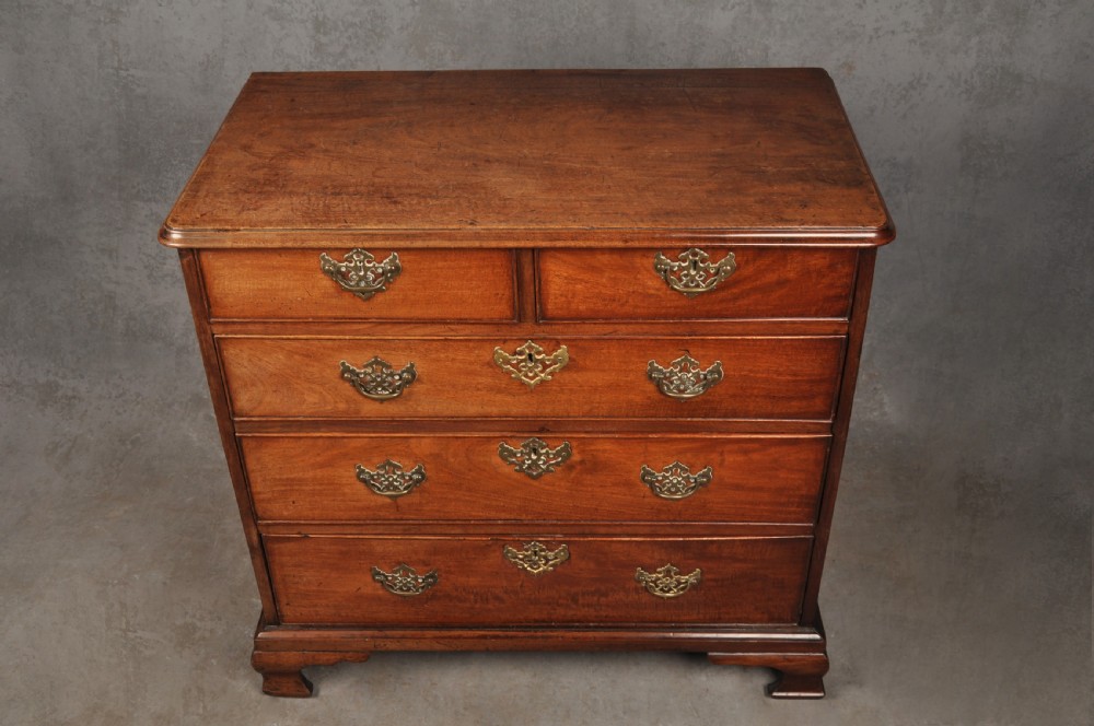 An 18th-century Georgian mahogany chest of drawers featuring two short over three long drawers with brass hardware and bracket feet. View III