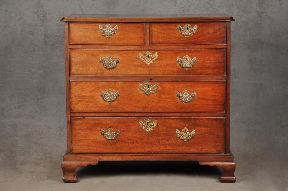 An 18th-century Georgian mahogany chest of drawers featuring two short over three long drawers with brass hardware and bracket feet. View XIII