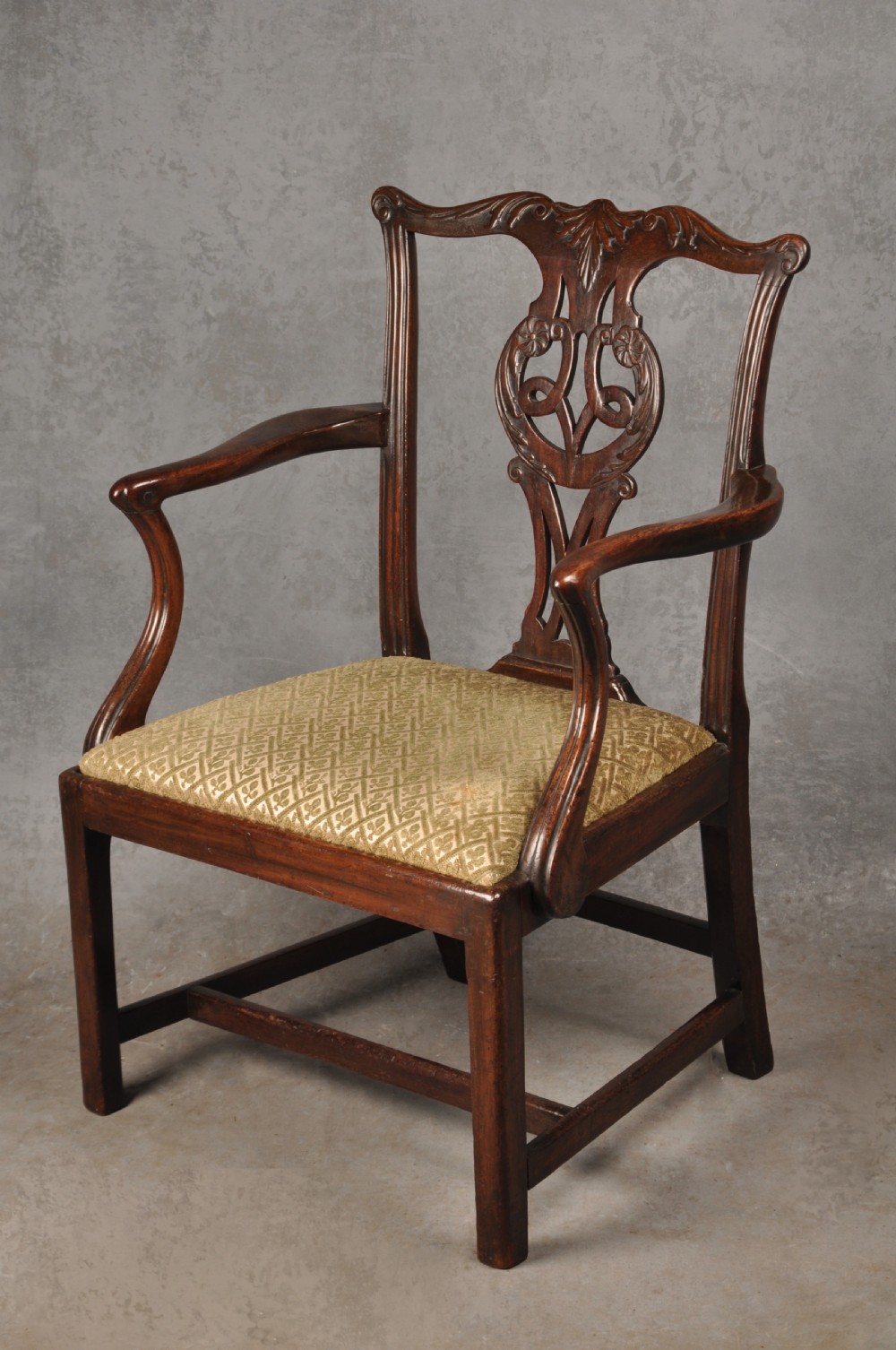 An 18th-century Chippendale mahogany open armchair featuring a carved pierced back splat, outswept arms, and a patterned fabric seat. View III