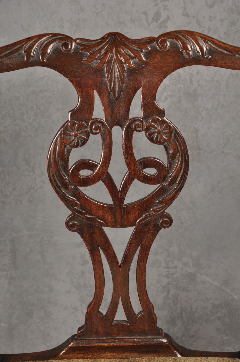 An 18th-century Chippendale mahogany open armchair featuring a carved pierced back splat, outswept arms, and a patterned fabric seat. View IV