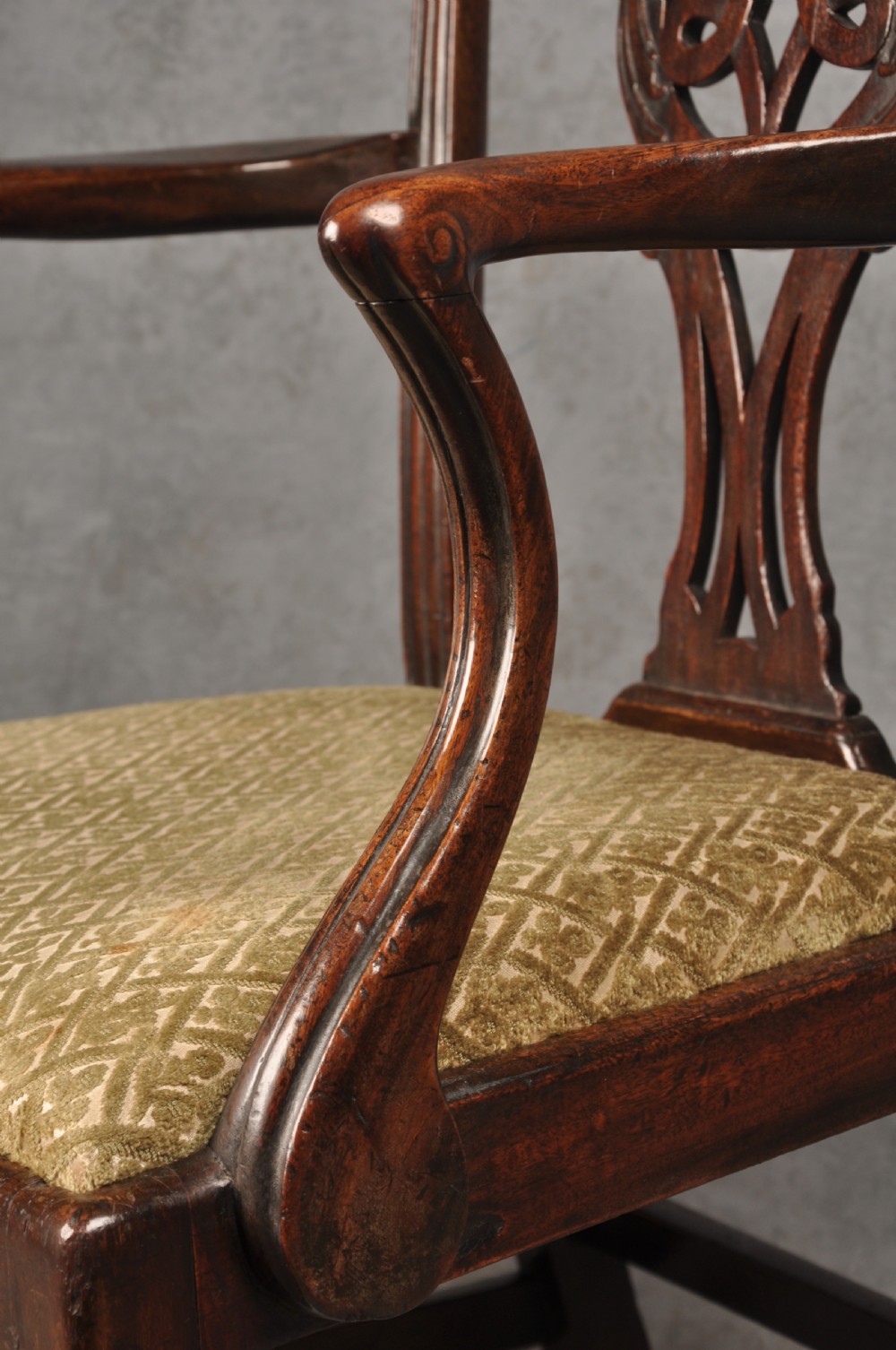 An 18th-century Chippendale mahogany open armchair featuring a carved pierced back splat, outswept arms, and a patterned fabric seat. View VIII