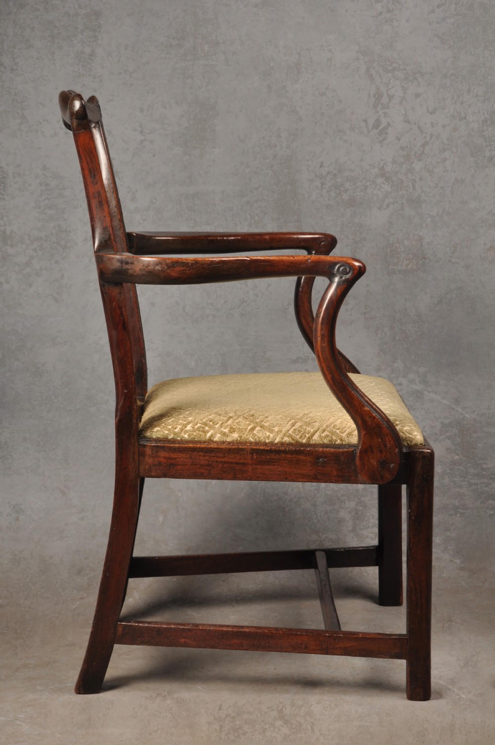 An 18th-century Chippendale mahogany open armchair featuring a carved pierced back splat, outswept arms, and a patterned fabric seat. View IX