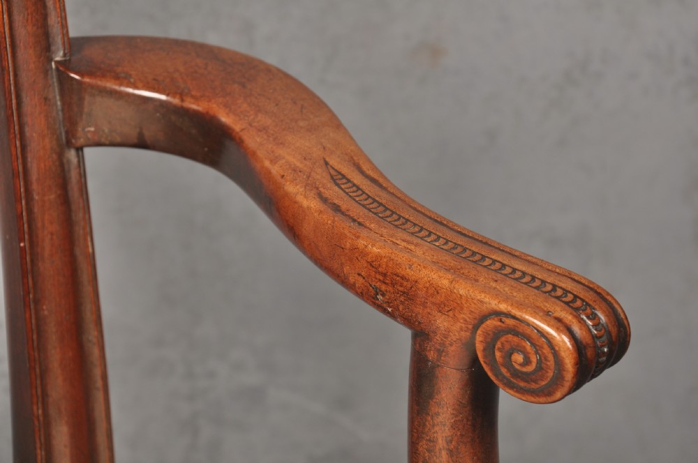 An 18th-century Chippendale mahogany armchair with a carved pierced back splat, curved arms, and a cream upholstered seat. View VIII
