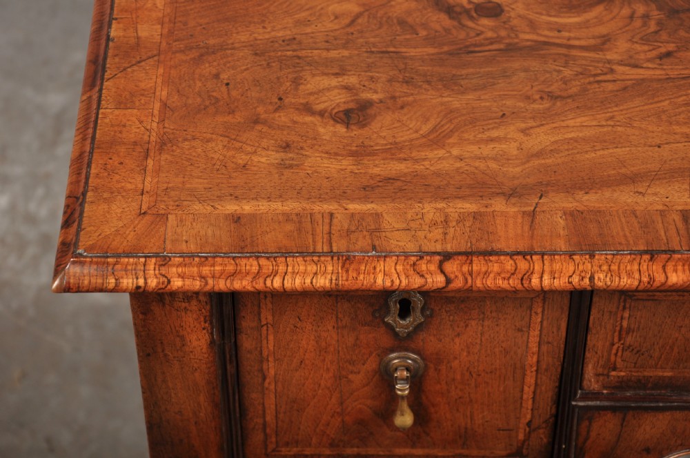 An 18th-century walnut lowboy table featuring three drawers with brass drop handles, a shaped lower apron, and cabriole legs. View IV