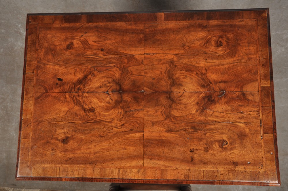 An 18th-century walnut lowboy table featuring three drawers with brass drop handles, a shaped lower apron, and cabriole legs. View V