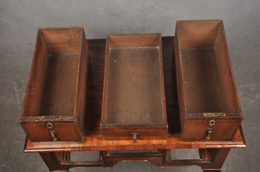 An 18th-century walnut lowboy table featuring three drawers with brass drop handles, a shaped lower apron, and cabriole legs. View IX