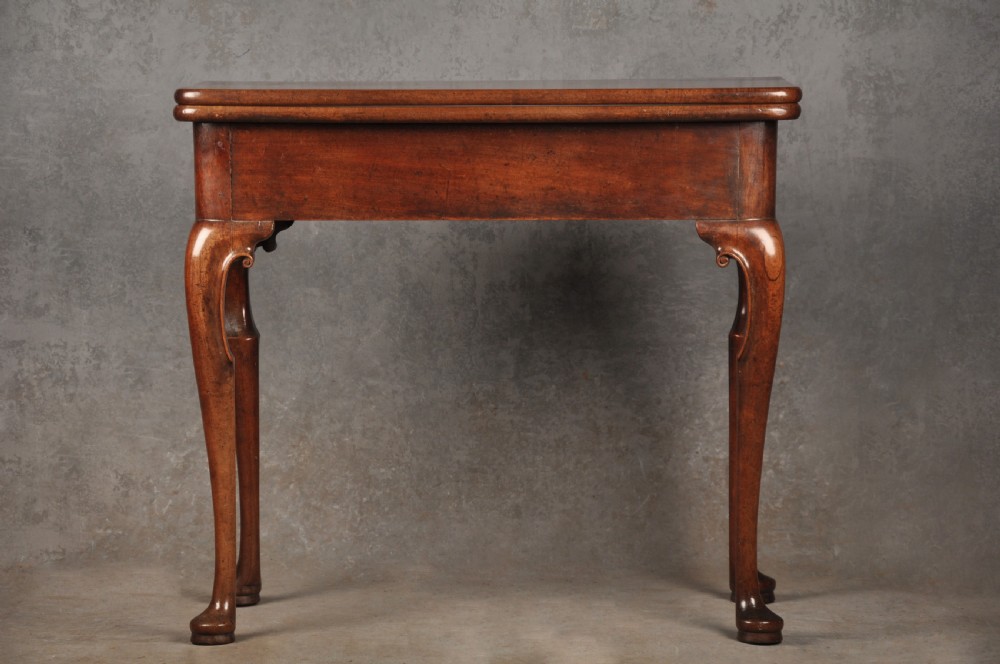 An 18th-century mahogany tea table featuring a folding rectangular top, concertina frame action, and cabriole legs with pad feet. View II