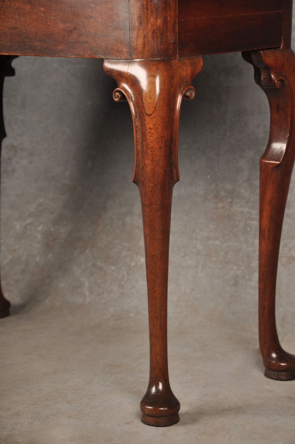 An 18th-century mahogany tea table featuring a folding rectangular top, concertina frame action, and cabriole legs with pad feet. View III