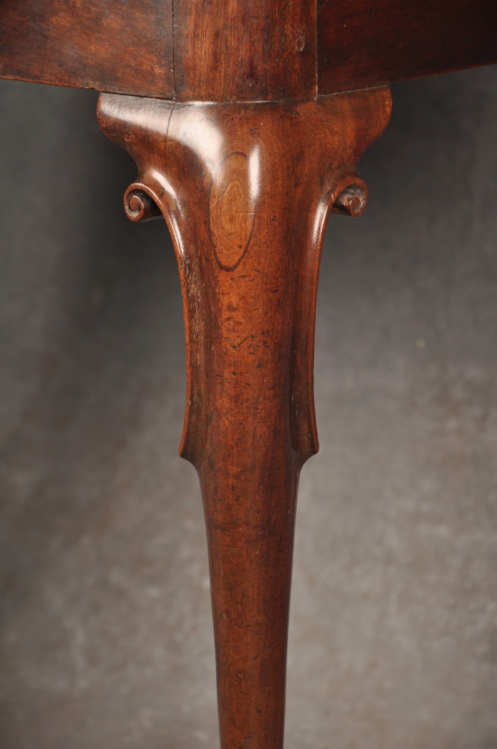 An 18th-century mahogany tea table featuring a folding rectangular top, concertina frame action, and cabriole legs with pad feet. View IV